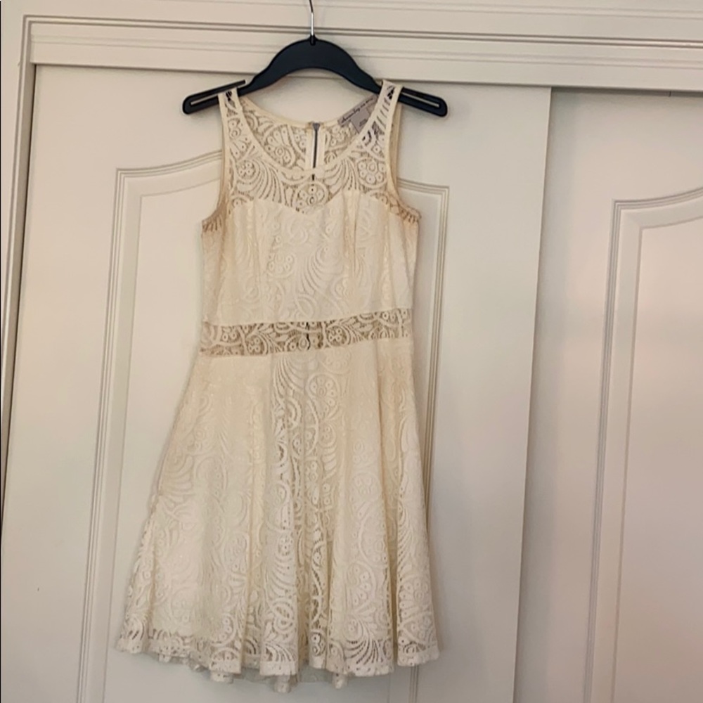 white lace cutout dress with added pocket